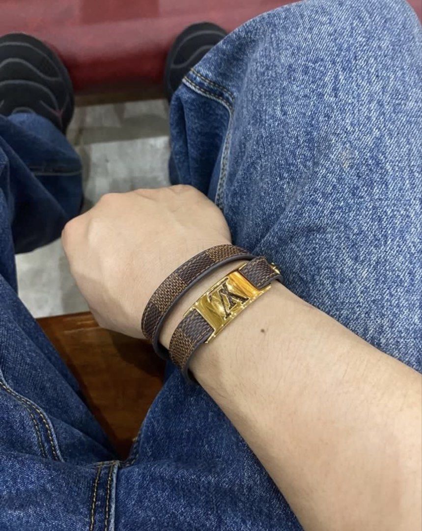Authentic Louis Vuitton (LV) Damier Ebene Double-Wrap Bracelet (Category: Luxury Accessories) located in Mandaluyong City. Submitted by material_boi (Listing ID 1451741103, Image 3). Description: Store bought at LV Greenbelt. Still priced at ₱22k at Farfetch. Lightly used. Complete with box and dustbag and paper bag. Belt type po yung closure. Gold na gold pa yan. One size only with 3 adjustment holes. Issue: some signs of use (if any) and maybe 