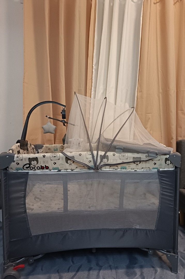 Baby Playpen with Changing Station and Mobile (Category: Cots & Cribs) located in Manila. Submitted by grandstone.d81dfc (Listing ID 1451848664, Image 2). Description: - Portable baby playpen with changing station - Includes mobile with hanging toys - Mesh sides for ventilation - Zippered door for easy access - Folds for storage and transport - Ideal for naps and playtime.