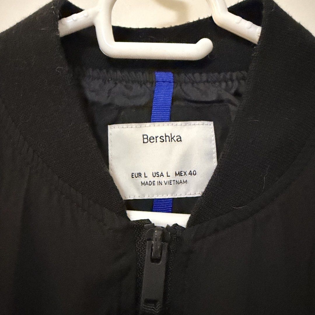 Bershka Black Bomber Jacket Size L (Category: Coats, Jackets and Outerwear) located in Bulacan. Submitted by declutter_diary02 (Listing ID 1451800026, Image 2). Description: - Brand: Bershka - Type: Black Bomber Jacket - Size: L - Features: Zip-up front, ribbed cuffs and hem, two front pockets with snap closures - Detail: Blue stripe lining - Origin: Made in Vietnam - Occasion: Great for casual wear PLEASE READ ‼️ MOP: Gcash or Bank transfer MOD: