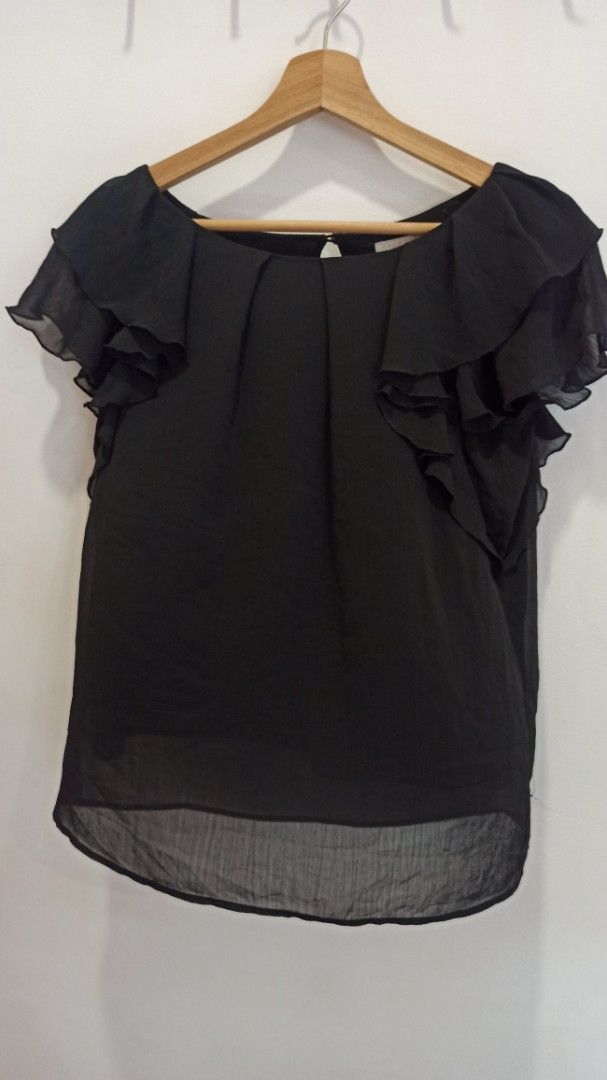 Black Chiffon Ruffle Blouse (Category: Blouses) located in Balakong. Submitted by rachel1564 (Listing ID 1451758541, Image 1). Description: - Black chiffon blouse - Ruffled sleeves and neckline - Pretty flutter sleeves - Keyhole detail at the back - Lightweight and flowy material - Versatile for dressing up or down - Easy to pair with skirts or pants.