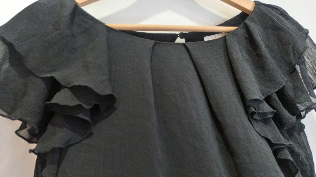 Black Chiffon Ruffle Blouse (Category: Blouses) located in Balakong. Submitted by rachel1564 (Listing ID 1451758541, Image 2). Description: - Black chiffon blouse - Ruffled sleeves and neckline - Pretty flutter sleeves - Keyhole detail at the back - Lightweight and flowy material - Versatile for dressing up or down - Easy to pair with skirts or pants.