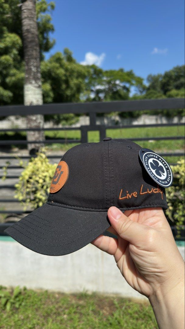 Black Clover Live Lucky Adjustable Baseball Cap (Category: Caps & Hats) located in Dasmarinas. Submitted by valuevibe (Listing ID 1451839791, Image 2). Description: Original Price: Php 2,200 ❌ Sale Price: Php 650 ✅ Brand: Black Clover Condition: Brand New - Classic black baseball cap - Features the official Black Clover logo on the front - 'Live Lucky' embroidered in vibrant orange on the side - Brand new with original tags attached.