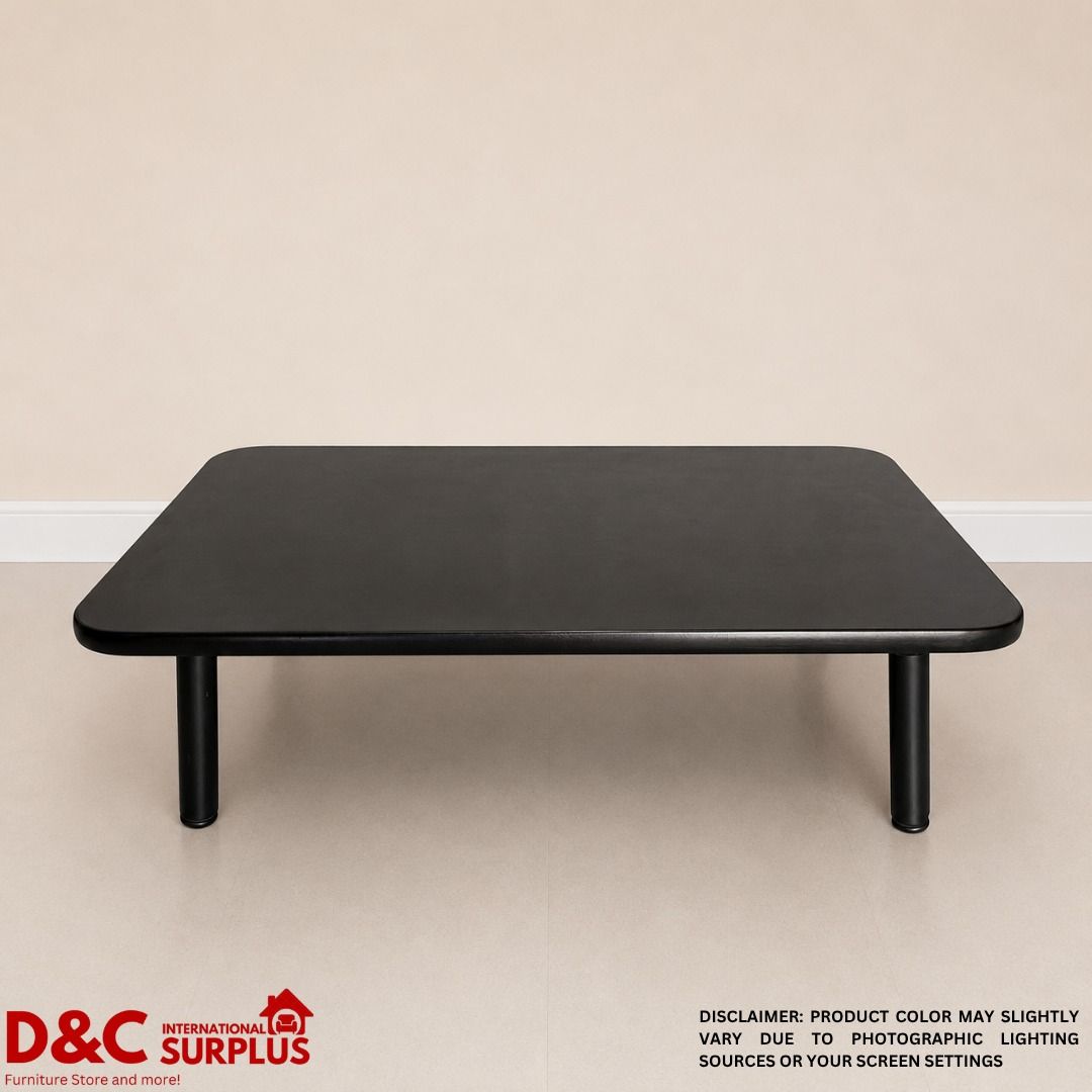 Black Foldable Coffee Table - 120cm x 75cm x 33cm (Category: Tables & Sets) located in Caloocan City. Submitted by dcintsurplus (Listing ID 1451810844, Image 2). Description: - Sleek black coffee table with a modern, simple design. - Rounded edges for a softer look and added safety. - Dimensions: 120cm (L) x 75cm (W) x 33cm (H). - Sturdy black legs attach securely underneath. - Underside reveals natural wood grain detail. - Functional and elegant