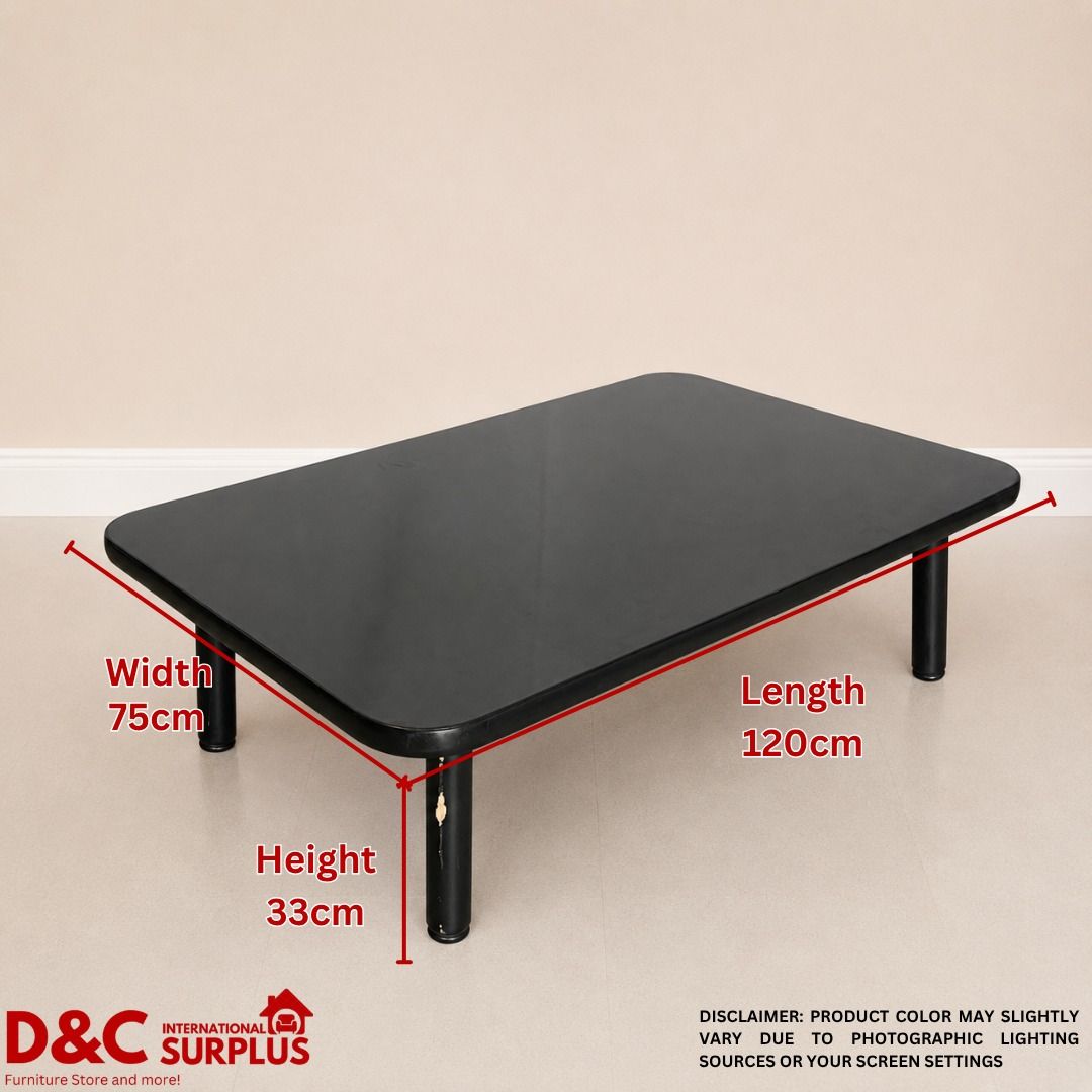 Black Foldable Coffee Table - 120cm x 75cm x 33cm (Category: Tables & Sets) located in Caloocan City. Submitted by dcintsurplus (Listing ID 1451810844, Image 3). Description: - Sleek black coffee table with a modern, simple design. - Rounded edges for a softer look and added safety. - Dimensions: 120cm (L) x 75cm (W) x 33cm (H). - Sturdy black legs attach securely underneath. - Underside reveals natural wood grain detail. - Functional and elegant