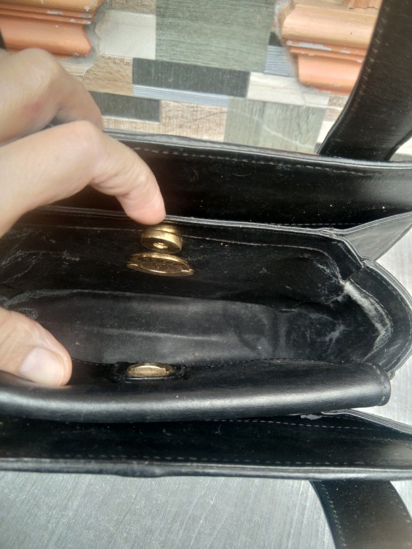 Black Stingray Leather Handbag (Category: Shoulder Bags) located in Manila. Submitted by mysticshark-0a05e9 (Listing ID 1451726868, Image 2). Description: - Classic black handbag - Genuine stingray leather with elegant gold accents - Two spacious main compartments - Comfortable top handles for carrying - Minor scuffs on edges - Interior lining shows some wear - Still a stylish and functional piece for everyday use.