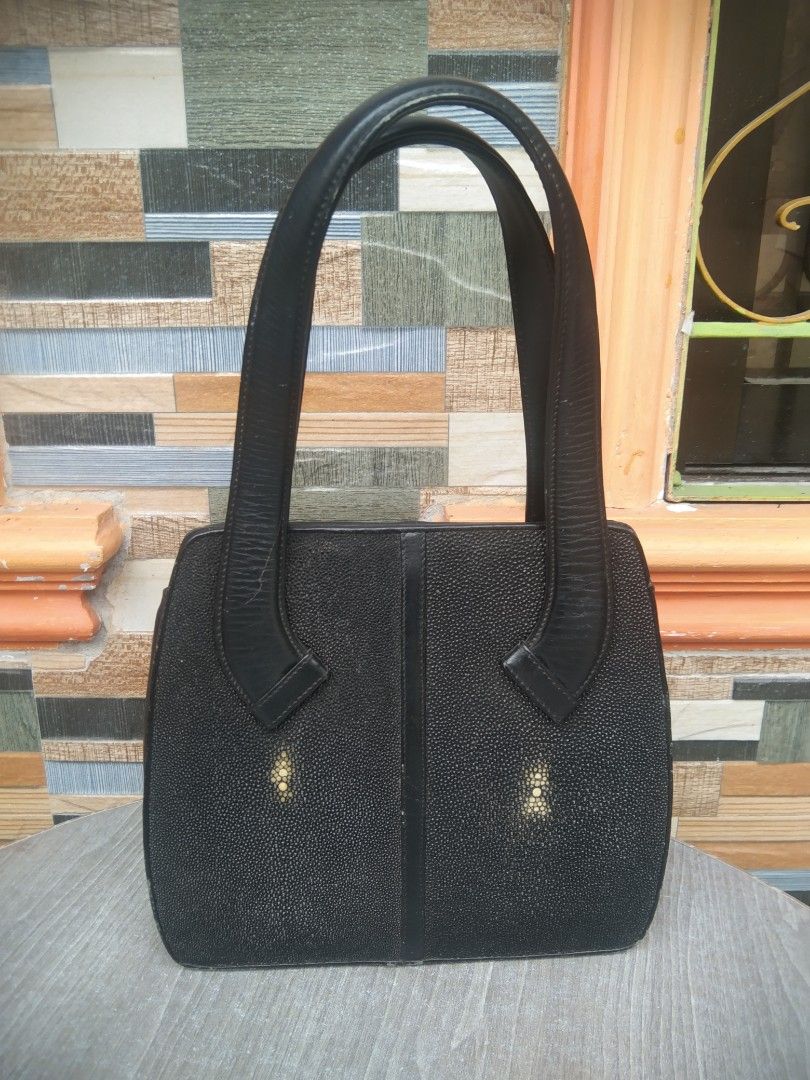 Black Stingray Leather Handbag (Category: Shoulder Bags) located in Manila. Submitted by mysticshark-0a05e9 (Listing ID 1451726868, Image 1). Description: - Classic black handbag - Genuine stingray leather with elegant gold accents - Two spacious main compartments - Comfortable top handles for carrying - Minor scuffs on edges - Interior lining shows some wear - Still a stylish and functional piece for everyday use.