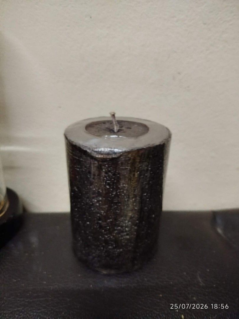 Black Textured Pillar Candle (Category: Home Fragrance) located in Quezon City. Submitted by chadrison (Listing ID 1451825974, Image 2). Description: - Black pillar candle - Textured finish - Metallic silver top detail - Approximately 4 inches tall - Lightly used, with plenty of burn time remaining - Ideal for home decor and creating a relaxing ambiance.