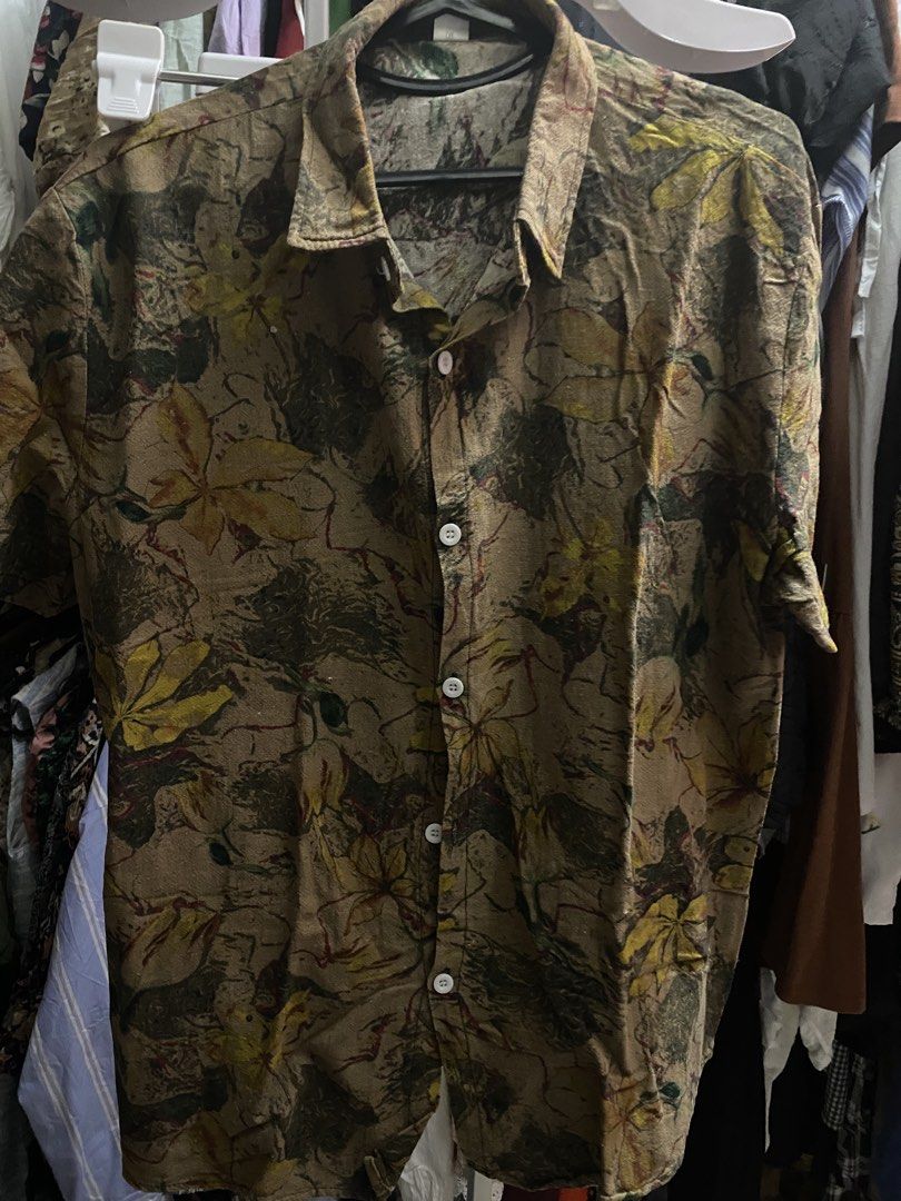 Brown Leaf Print Short Sleeve Button Up Shirt (Category: Shirts) located in Bauang. Submitted by nrrandomthings (Listing ID 1451702449, Image 1). Description: - Cool brown shirt with a stylish leaf print. - Short sleeves and a button-up front. - Ideal for casual outings. - Designed for a loose and comfortable fit..