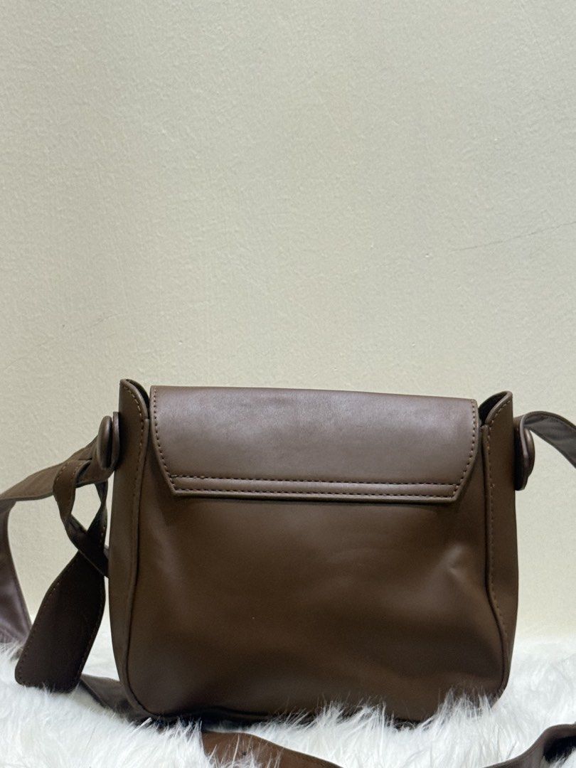 Tan Brown Flap Shoulder Crossbody Bag (Category: Cross-body Bags) located in Quezon City. Submitted by clazzystudio (Listing ID 1451846409, Image 3). Description: Selling this chic tan brown crossbody bag featuring a smooth faux leather finish, clean contrast edge coating, and stylish top hardware accents. It features a fold-over flap closure and a long adjustable shoulder strap. Perfect for adding a warm, classic, and minimalist touch to your da