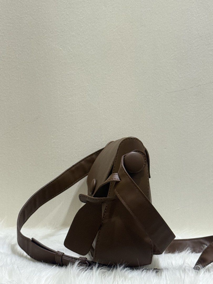 Tan Brown Flap Shoulder Crossbody Bag (Category: Cross-body Bags) located in Quezon City. Submitted by clazzystudio (Listing ID 1451846409, Image 2). Description: Selling this chic tan brown crossbody bag featuring a smooth faux leather finish, clean contrast edge coating, and stylish top hardware accents. It features a fold-over flap closure and a long adjustable shoulder strap. Perfect for adding a warm, classic, and minimalist touch to your da