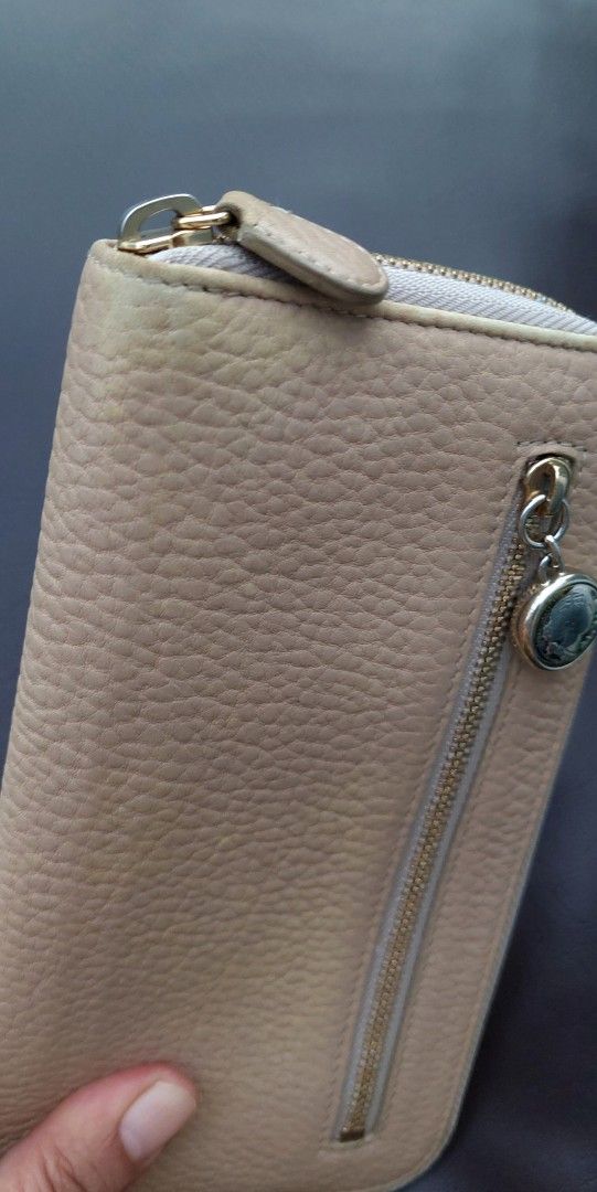 BVLGARI Leather Zip Around Wallet Beige (Category: Luxury Bags & Wallets) located in Makati City. Submitted by heinzly (Listing ID 1451896752, Image 2). Description: BVLGARI wallet - Color: Beige pebbled leather - Hardware: Gold - Closure: Zip around - Features: Front zip pocket with charm - Overall: Still has a lot of life left This wallet is being sold at a price that reflects its current condition, including normal signs of use, minor flaws, a