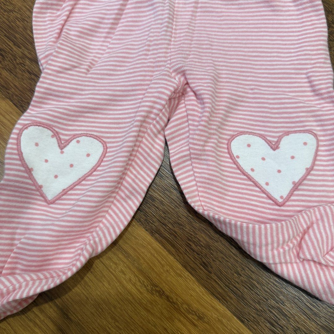 Carter's Baby Girl Pink Polka Dot & Heart Sleeping set 6 Months (Category: Babies & Kids Fashion) located in Petaling Jaya. Submitted by auroraaa (Listing ID 1451863815, Image 2). Description: - Brand: Carter's - Size: 6 months - Top: White long-sleeve wrap top with pink polka dots and airplane detail - Pants: Pink and white striped with heart patches on knees and ruffled cuffs - Slight yellow stain due to storage.