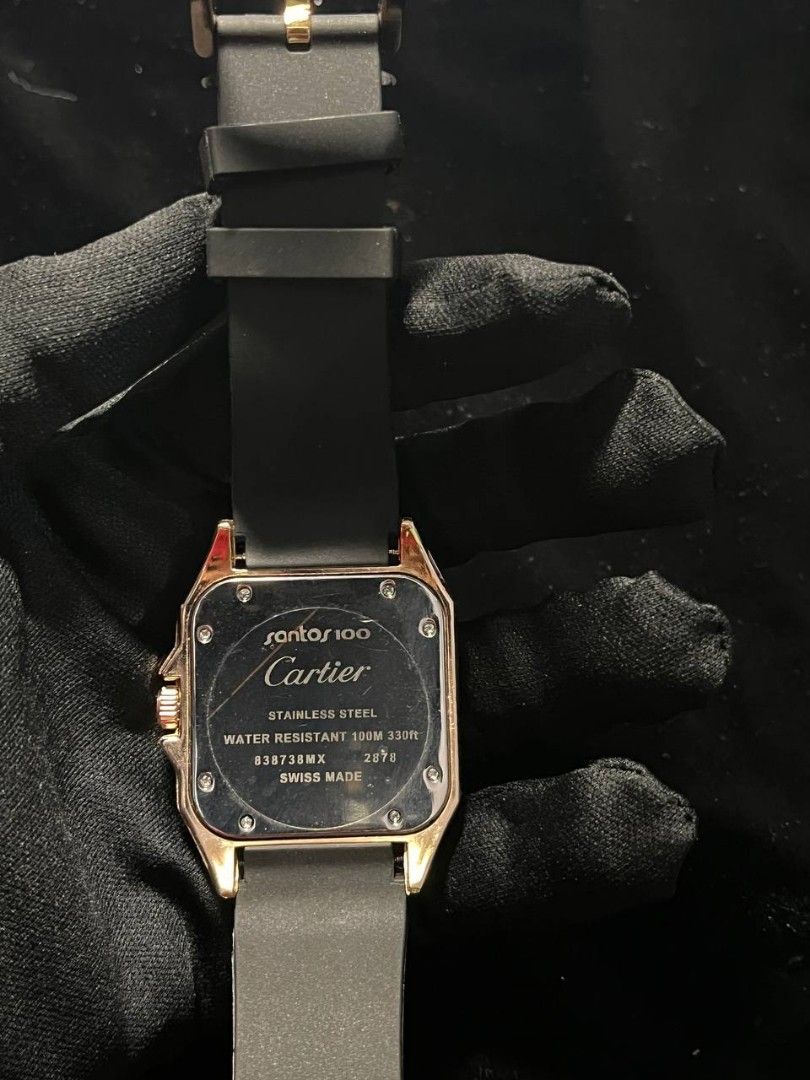 Cartier Santos 100 Rose Gold Black Dial Rubber Strap Watch (Category: Luxury Watches) located in Manila. Submitted by seannathan46011 (Listing ID 1451870607, Image 2). Description: - OEM Cartier Santos 100 Watch - Luxurious Rose Gold and Stainless Steel Case - Elegant Black Dial with Roman Numerals - Convenient Date Window at 3 o'clock - Durable Black Rubber Strap - Rose Gold Buckle with Cartier Engraving - Water Resistant up to 100 Meters .