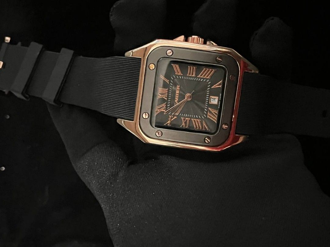 Cartier Santos 100 Rose Gold Black Dial Rubber Strap Watch (Category: Luxury Watches) located in Manila. Submitted by seannathan46011 (Listing ID 1451870607, Image 1). Description: - OEM Cartier Santos 100 Watch - Luxurious Rose Gold and Stainless Steel Case - Elegant Black Dial with Roman Numerals - Convenient Date Window at 3 o'clock - Durable Black Rubber Strap - Rose Gold Buckle with Cartier Engraving - Water Resistant up to 100 Meters .