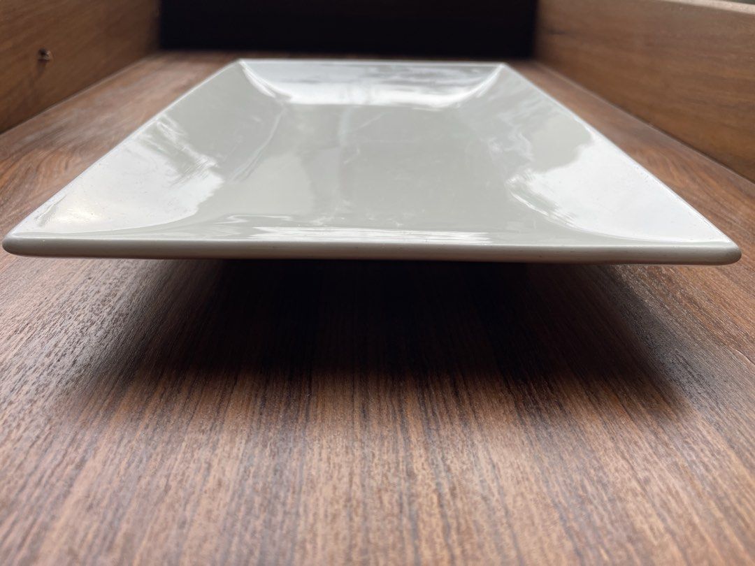 Ceramics Essentials Rectangular Serving Platter White (Category: Dinnerware & Cutlery) located in Singapore. Submitted by goodman1063 (Listing ID 1451793387, Image 3). Description: - White rectangular serving platter - Brand: Ceramica Essentials - Ideal for appetizers, sushi, or small bites - Shows light surface scratches from normal use - Clean and ready for its new home.