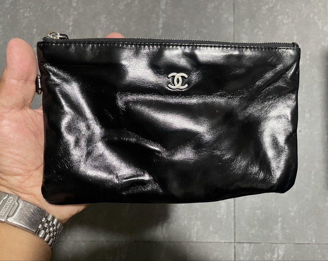 Chanel Shiny Calfskin Pouch (Category: Luxury Bags & Wallets) located in Calapan. Submitted by lucasthrifts (Listing ID 1451805560, Image 1). Description: - Black patent leather pouch - Quilted satin lining - Silver zipper closure with Chanel logo detail - Ideal for organizing essentials or as a standalone clutch - Clean inside and out.