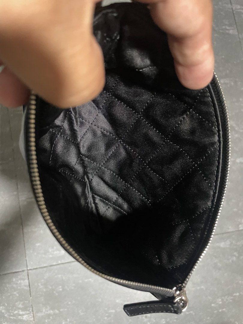 Chanel Shiny Calfskin Pouch (Category: Luxury Bags & Wallets) located in Calapan. Submitted by lucasthrifts (Listing ID 1451805560, Image 2). Description: - Black patent leather pouch - Quilted satin lining - Silver zipper closure with Chanel logo detail - Ideal for organizing essentials or as a standalone clutch - Clean inside and out.