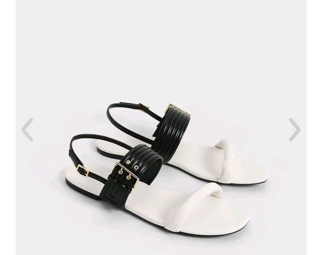Charles & Keith Black & White Strap Sandals (Category: Flats & Sandals) located in Quezon City. Submitted by jcycle02 (Listing ID 1451732254, Image 1). Description: - Brand: Charles & Keith - Color: White base with black ribbed straps - Closure: Adjustable ankle strap with buckle - Details: Gold hardware - Size: 36 - Origin: Made in China - Style: Great for casual wear never used..