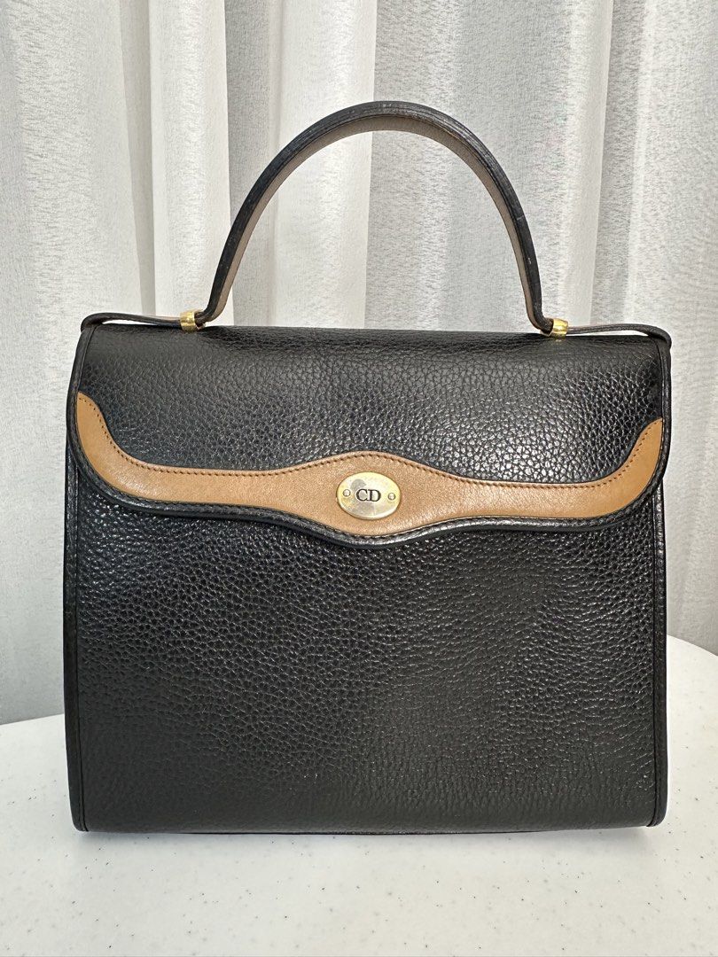 Christian Dior Kelly Handbag (Category: Luxury Bags & Wallets) located in Manila. Submitted by sellerseller19 (Listing ID 1451803628, Image 1). Description: - Classic black leather handbag by Christian Dior - Tan trim detail on the front flap - Gold-tone hardware with iconic CD logo charm - Interior zip pocket for essentials - Authentically Made in France - A timeless addition to any collection.