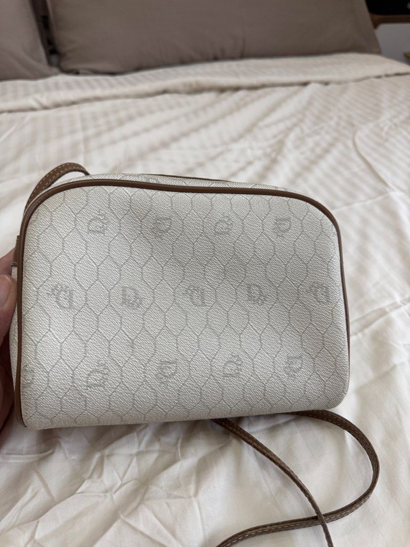 Christian Dior Monogram Canvas Crossbody Bag (Category: Luxury Bags & Wallets) located in Quezon City. Submitted by pinkpracticalmom (Listing ID 1451753536, Image 3). Description: - Authentic vintage Christian Dior crossbody bag - Iconic Diorissimo monogram pattern (white & brown) - Brown leather trim and strap - Secure zipper closure Dimension- 22cm width x 17cm height. 60cm strap drop. No inclusions..