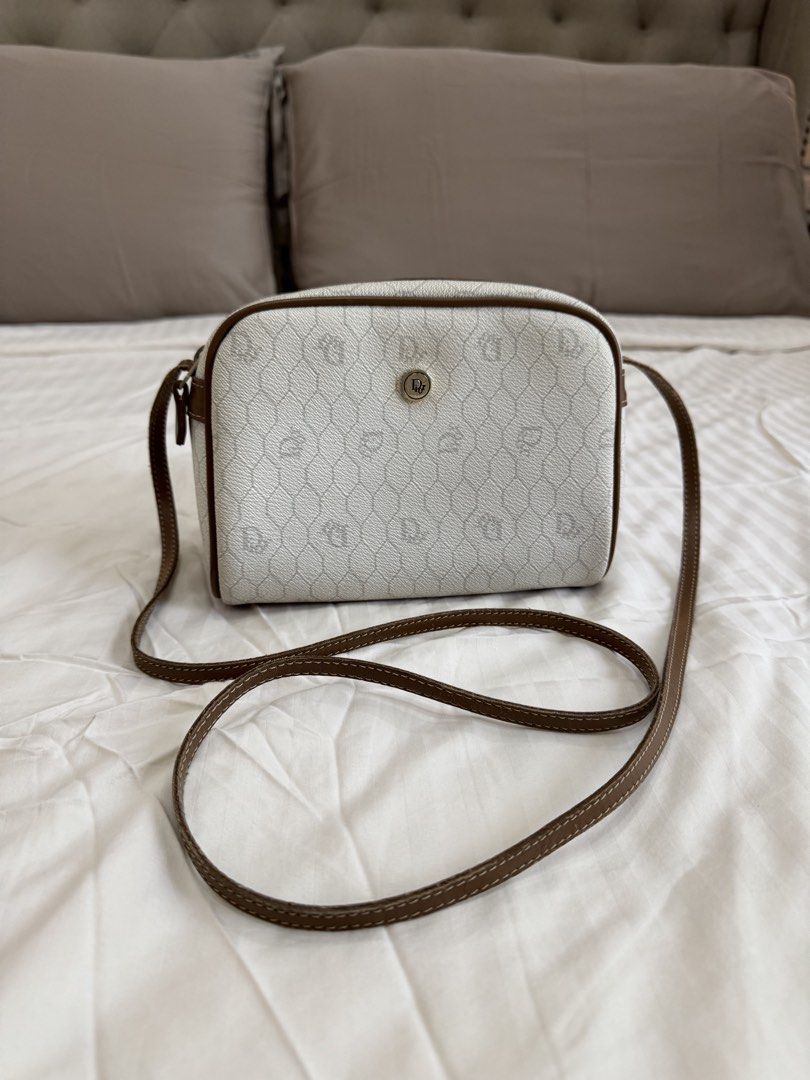Christian Dior Monogram Canvas Crossbody Bag (Category: Luxury Bags & Wallets) located in Quezon City. Submitted by pinkpracticalmom (Listing ID 1451753536, Image 1). Description: - Authentic vintage Christian Dior crossbody bag - Iconic Diorissimo monogram pattern (white & brown) - Brown leather trim and strap - Secure zipper closure Dimension- 22cm width x 17cm height. 60cm strap drop. No inclusions..