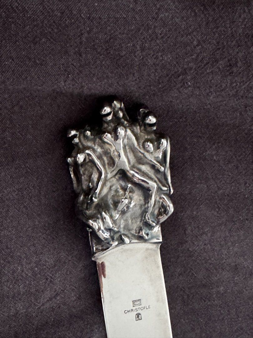 Christofle Silver Letter Opener with Figural Handle (Category: Vintage Collectibles) located in Makati City. Submitted by tinkerboy (Listing ID 1451709210, Image 2). Description: - Vintage Christofle letter opener - Features a detailed figural handle with multiple figures - Blade marked with Christofle hallmark - Also bears a Philip Morris mark - Unique and stylish desk accessory.