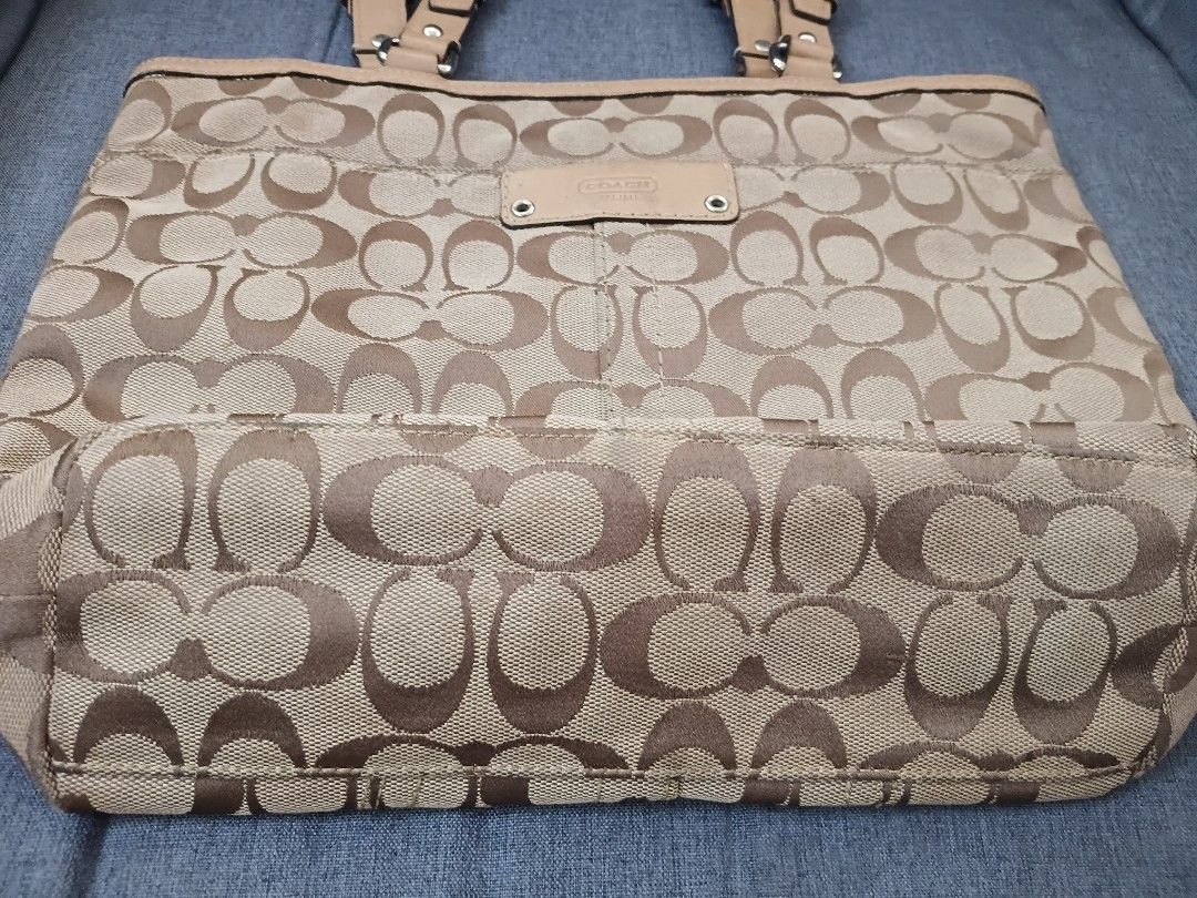 Coach Monogram Canvas Leather Trim Tote Bag (Category: Luxury Bags & Wallets) located in Binangonan. Submitted by chingtp (Listing ID 1451756131, Image 2). Description: - Classic Coach monogram tote bag - Tan and brown signature pattern - Genuine leather trim and handles - Stylish buckle details on straps - Ample interior space for essentials - Ideal for everyday use.