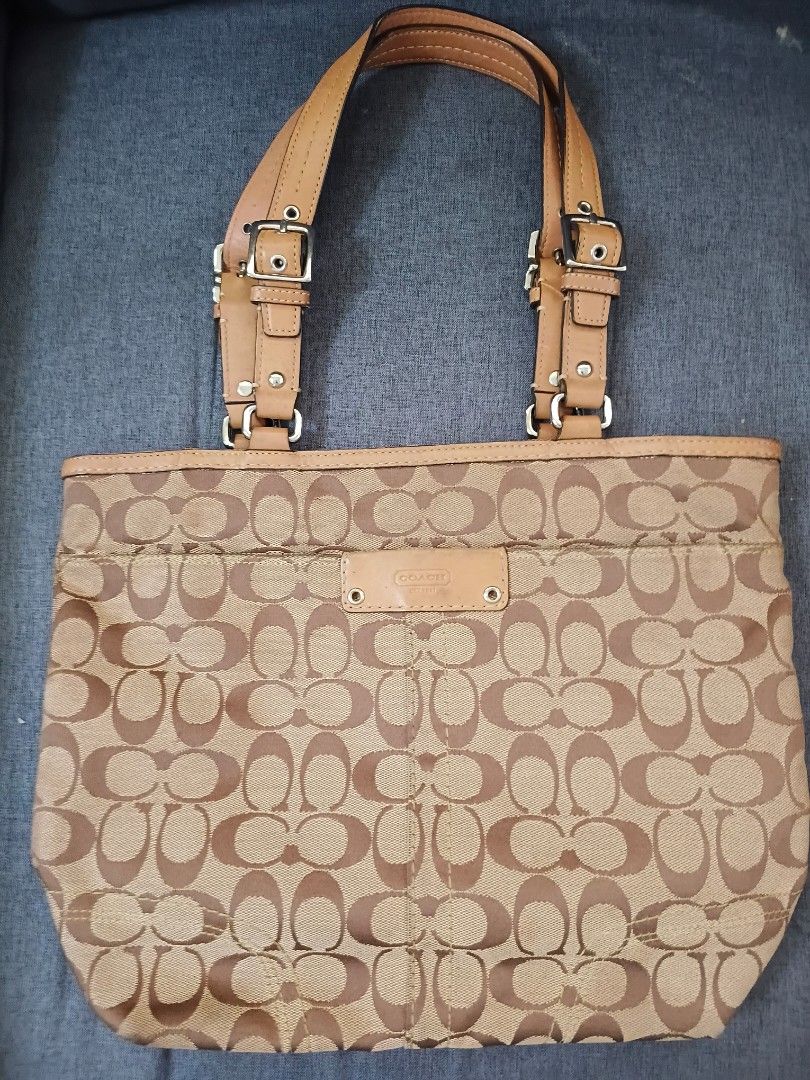 Coach Monogram Canvas Leather Trim Tote Bag (Category: Luxury Bags & Wallets) located in Binangonan. Submitted by chingtp (Listing ID 1451756131, Image 1). Description: - Classic Coach monogram tote bag - Tan and brown signature pattern - Genuine leather trim and handles - Stylish buckle details on straps - Ample interior space for essentials - Ideal for everyday use.