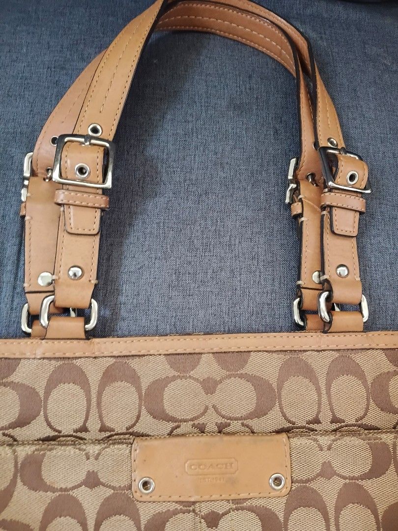 Coach Monogram Canvas Leather Trim Tote Bag (Category: Luxury Bags & Wallets) located in Binangonan. Submitted by chingtp (Listing ID 1451756131, Image 3). Description: - Classic Coach monogram tote bag - Tan and brown signature pattern - Genuine leather trim and handles - Stylish buckle details on straps - Ample interior space for essentials - Ideal for everyday use.
