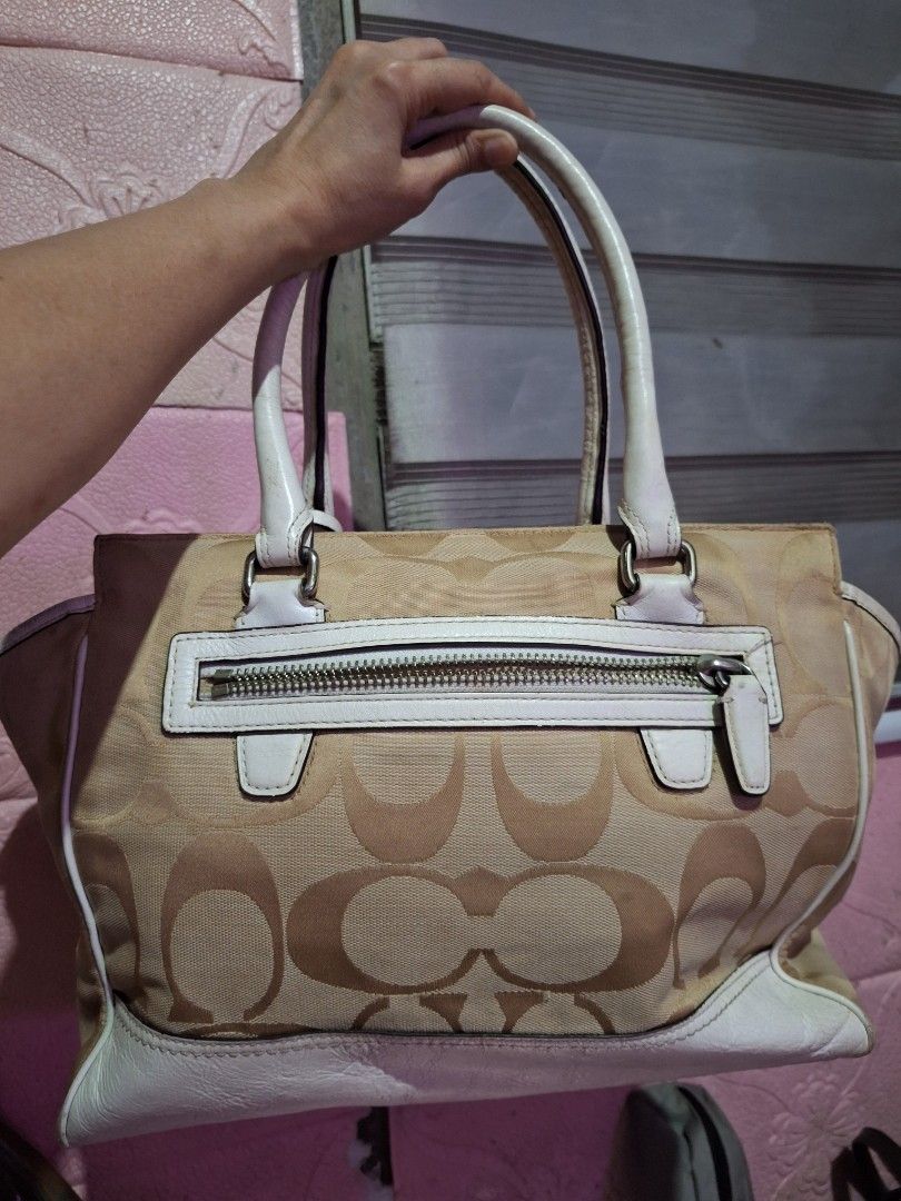 Coach Monogram Canvas Leather Trimmed Handbag (Category: Luxury Bags & Wallets) located in Quezon City. Submitted by cloudymay (Listing ID 1451788457, Image 3). Description: - Authentic Coach monogram canvas handbag - Classic tan and white colorway - Durable leather trim and handles - Stylish tassel details - Interior zippered pocket for essentials - Shows some signs of wear on the leather but still very pretty and clean canvass. - Ideal everyday