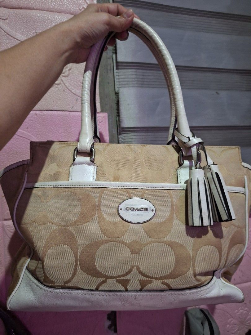 Coach Monogram Canvas Leather Trimmed Handbag (Category: Luxury Bags & Wallets) located in Quezon City. Submitted by cloudymay (Listing ID 1451788457, Image 1). Description: - Authentic Coach monogram canvas handbag - Classic tan and white colorway - Durable leather trim and handles - Stylish tassel details - Interior zippered pocket for essentials - Shows some signs of wear on the leather but still very pretty and clean canvass. - Ideal everyday