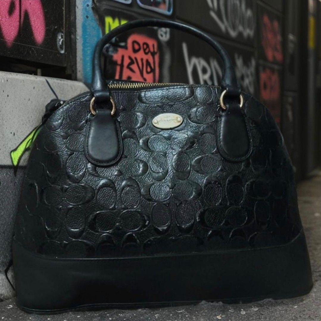 Coach Sierra (Category: Luxury Bags & Wallets) located in Manila. Submitted by bellissima05 (Listing ID 1451879282, Image 1). Description: Coach satchel purse embossed leather w/ gold zipper and logo mid size rare find. nag balat lang un label nya sa loob but this is an authentic Coach bag 100%. • Handles with 3.5” drop & removable crossbody strap • Gold-tone hardware, domed shape • Approx. 8″ L × 6″ H × 3.25″ D.