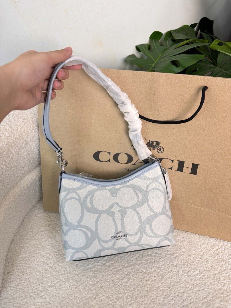 Coach Signature Monogram Shoulder Bag Light Blue (Category: Luxury Bags & Wallets) located in Pasay City. Submitted by bagsobssessiob (Listing ID 1451701131, Image 1). Description: - Authentic Coach shoulder bag - Signature monogram print - Chic light blue and white colorway - Strap still in original protective plastic - Comes with original Coach shopping bag - Ideal for everyday wear and tear.