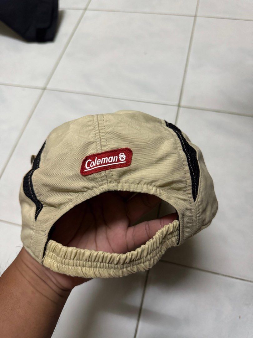 Coleman Beige Outdoor Cap Hat (Category: Cap & Hats) located in Kota Bharu. Submitted by sellclothesandbag (Listing ID 1451854115, Image 3). Description: - Brand: Coleman - Color: Beige with brown brim - Features: Black mesh accents on sides, adjustable elastic strap at the back - Ideal for: Outdoor activities - Condition: Good, with some signs of wear.