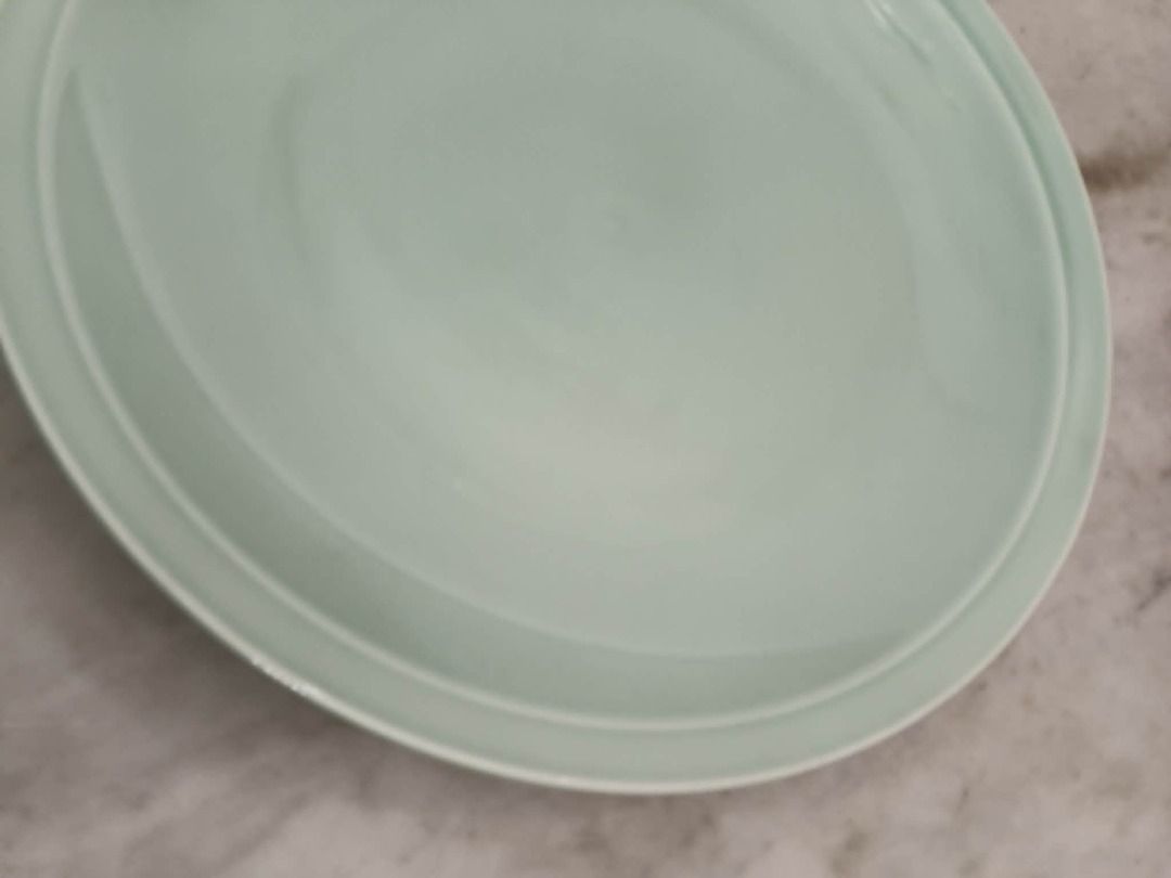 Decluttering pre-loved celadon large plate 18 inch diameter (Category: Dinnerware & Cutlery) located in Taytay. Submitted by gara1124 (Listing ID 1451718868, Image 3). Description: Decluttering pre-loved celadon large plate 18 inch diameter Price: P1500 color may vary due to lighting Location: near Tikling, Taytay NO COD Payment upon pick up - Elegant light green ceramic serving plate - Smooth, glossy finish - Diameter: Approximately 12 inches - 
