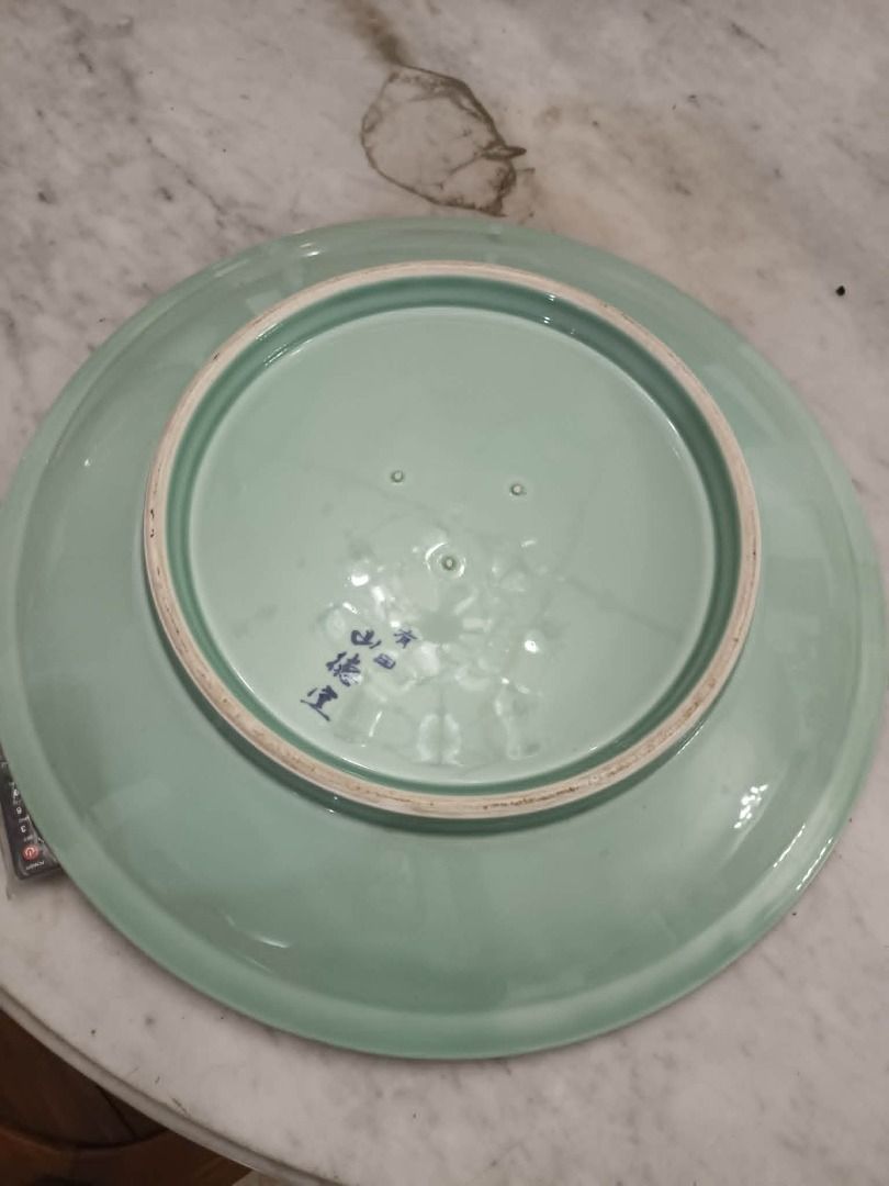 Decluttering pre-loved celadon large plate 18 inch diameter (Category: Dinnerware & Cutlery) located in Taytay. Submitted by gara1124 (Listing ID 1451718868, Image 2). Description: Decluttering pre-loved celadon large plate 18 inch diameter Price: P1500 color may vary due to lighting Location: near Tikling, Taytay NO COD Payment upon pick up - Elegant light green ceramic serving plate - Smooth, glossy finish - Diameter: Approximately 12 inches - 