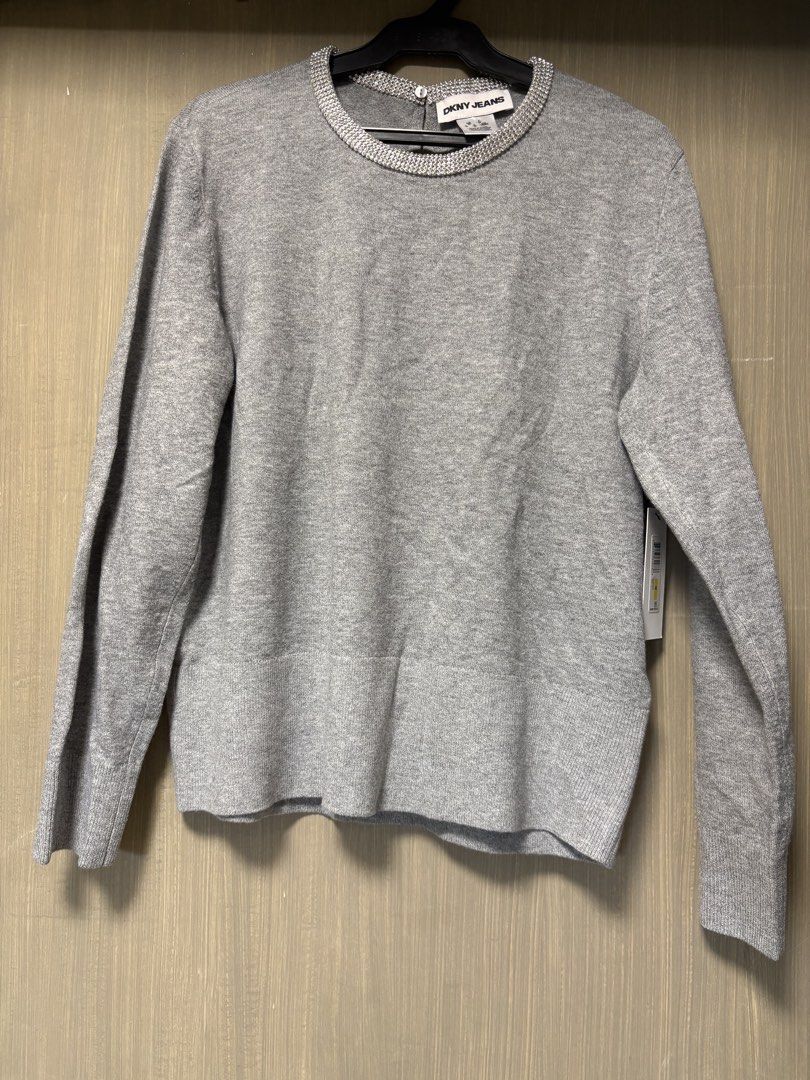 DKNY Jeans Grey Embellished Neck Sweater (Category: Coats, Jackets and Outerwear) located in Quezon City. Submitted by ejay75 (Listing ID 1451768476, Image 1). Description: - DKNY Jeans grey long-sleeved sweater - Features a sparkly embellished neckline - Classic and simple design - Ideal for layering or wearing solo - Comfortable and stylish US MEDIUM SIZE. RUNS BIG TAG INTACT BRANDNEW.
