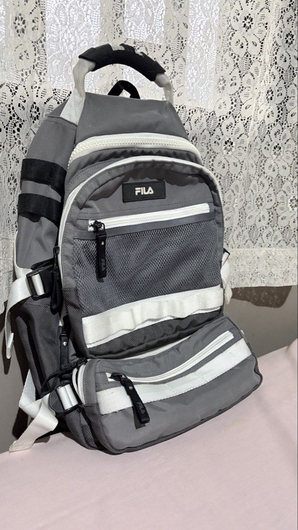 FILA Grey Sling Backpack Bag (Category: Backpacks) located in Marikina City. Submitted by victoryinjesus (Listing ID 1451791594, Image 2). Description: - Grey FILA sling backpack - Multiple zippered pockets - Mesh detailing - White accents and straps - Ideal for everyday use or travel - Spacious for essentials - Adjustable strap for comfort.