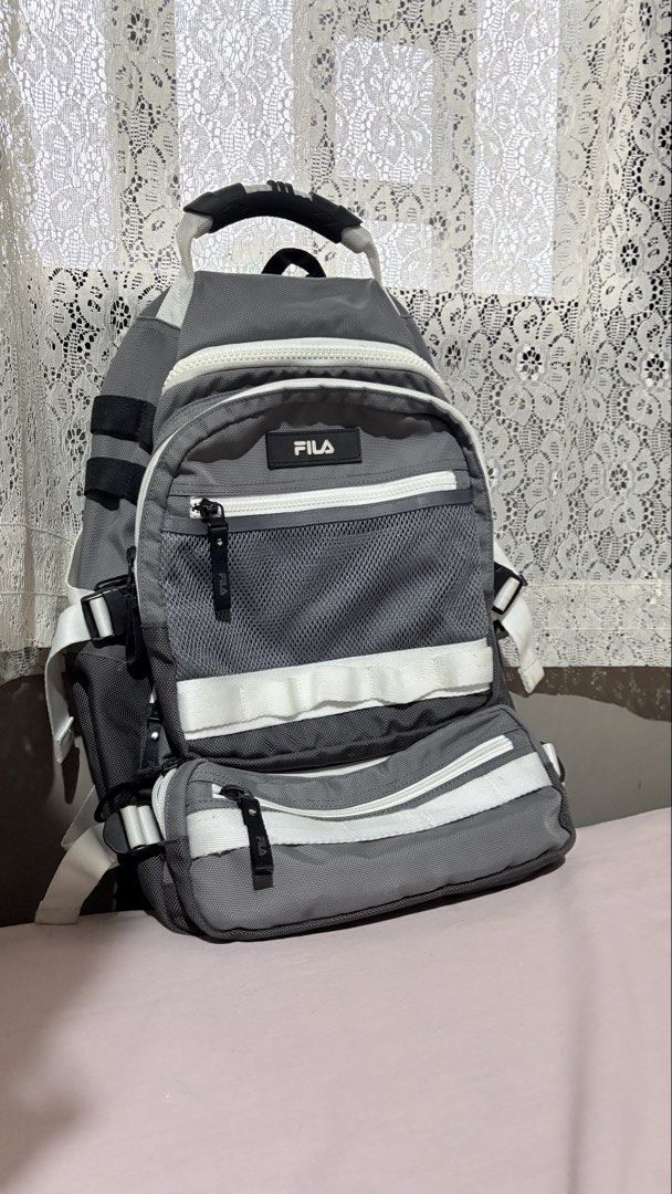 FILA Grey Sling Backpack Bag (Category: Backpacks) located in Marikina City. Submitted by victoryinjesus (Listing ID 1451791594, Image 1). Description: - Grey FILA sling backpack - Multiple zippered pockets - Mesh detailing - White accents and straps - Ideal for everyday use or travel - Spacious for essentials - Adjustable strap for comfort.