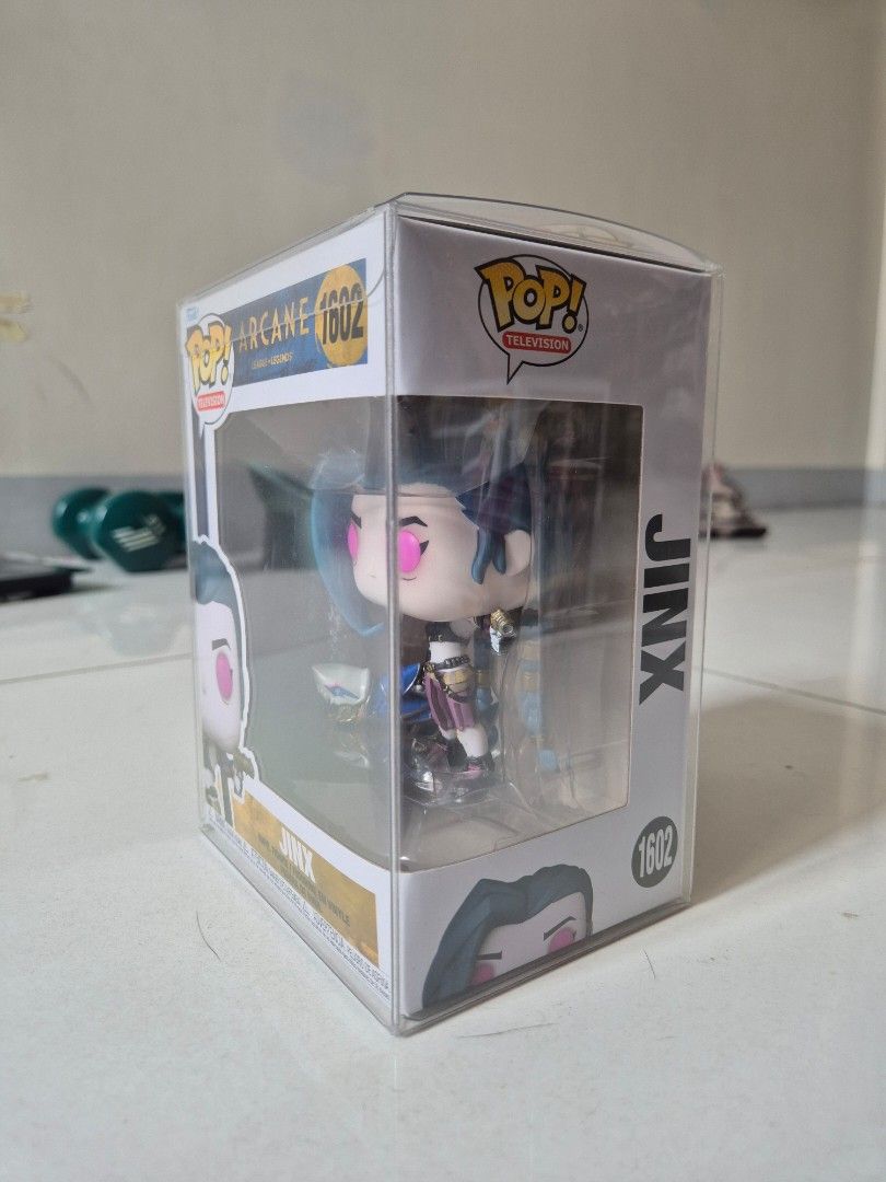 Funko Pop Arcance Jinx (Category: Designer & Blind Box Toys) located in Manila. Submitted by sey_rahh (Listing ID 1451738826, Image 2). Description: Selling authentic Funko Pop! Jinx #1602 from the hit Netflix series Arcane / League of Legends. ​Item Details: ​Character: Jinx (#1602) ​Series: Pop! Television / Arcane: League of Legends ​Condition: Excellent box condition (Never removed from box) Includes: Comes enclosed in a clear acrylic / hard 
