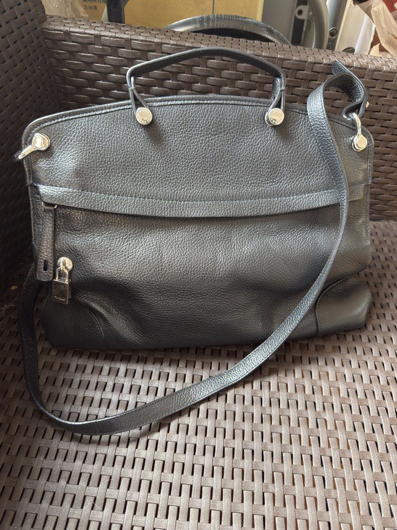 Furla Black Leather Handbag with Shoulder Strap (Category: Luxury Bags & Wallets) located in Paranaque City. Submitted by banditsassy (Listing ID 1451699471, Image 1). Description: Authentic Furla genuine pebbled leather bag in classic Onyx (black) with silver-tone hardware. Can be carried by hand or worn crossbody/shoulder using the detachable strap. Spacious enough for work essentials, making it perfect as an everyday or office bag. - Ideal for