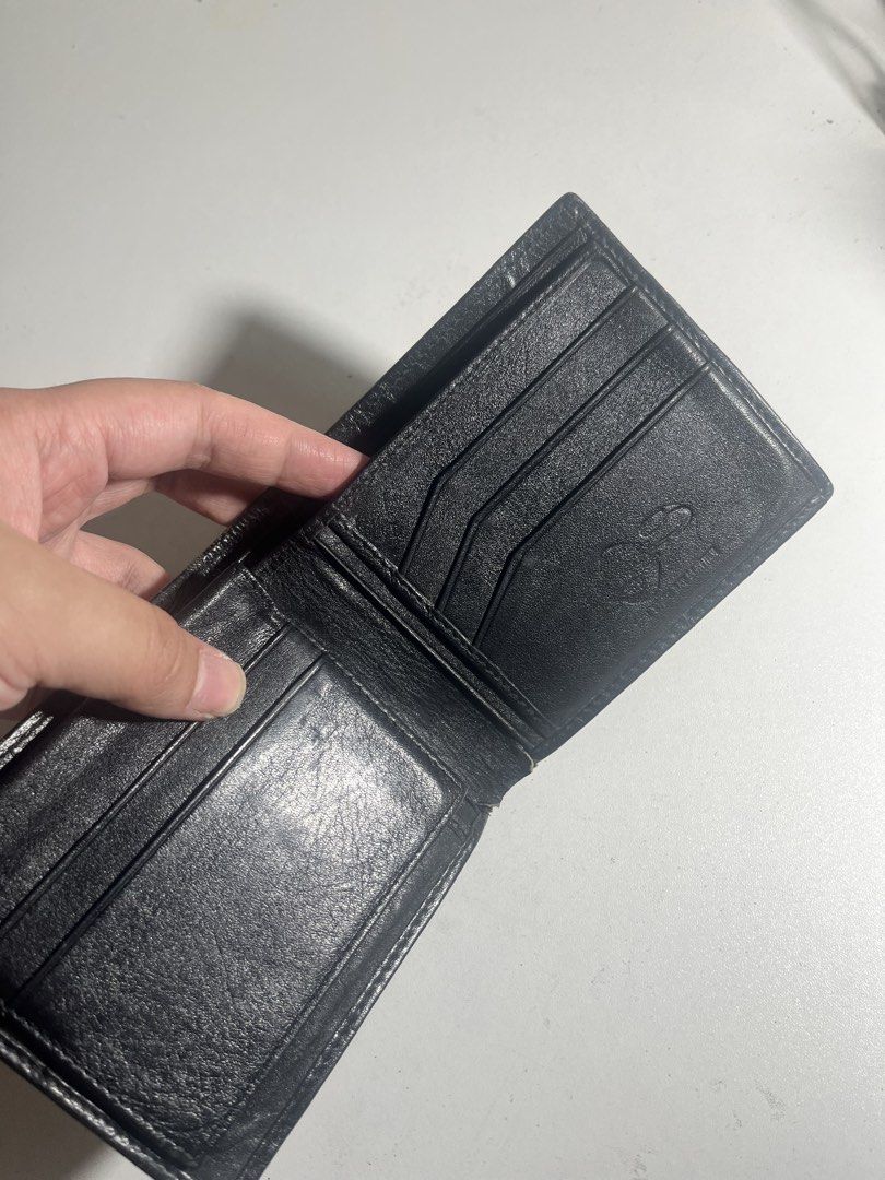 Genuine Black Stingray Leather Bifold Wallet (Category: Wallets & Card holders) located in Manila. Submitted by mjdeclutters.mnl (Listing ID 1451827832, Image 3). Description: - Crafted from genuine black stingray leather. - Distinctive 'eye' pattern on the front for a unique look. - Bifold design for a slim profile. - Multiple card slots to keep your essentials organized. - Spacious bill compartment for your cash. - Clean and classic design, per