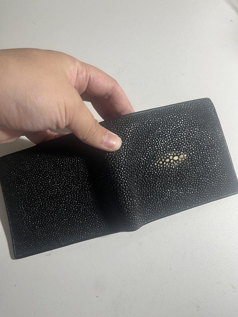 Genuine Black Stingray Leather Bifold Wallet (Category: Wallets & Card holders) located in Manila. Submitted by mjdeclutters.mnl (Listing ID 1451827832, Image 2). Description: - Crafted from genuine black stingray leather. - Distinctive 'eye' pattern on the front for a unique look. - Bifold design for a slim profile. - Multiple card slots to keep your essentials organized. - Spacious bill compartment for your cash. - Clean and classic design, per