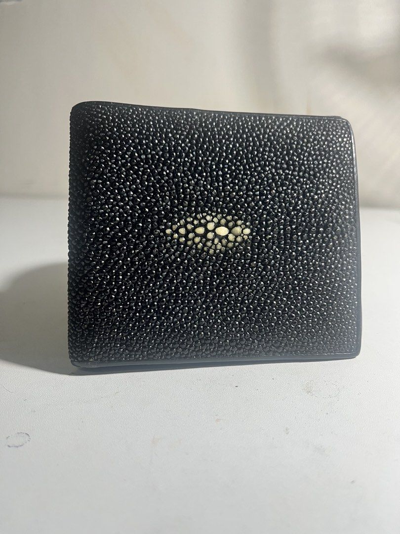 Genuine Black Stingray Leather Bifold Wallet (Category: Wallets & Card holders) located in Manila. Submitted by mjdeclutters.mnl (Listing ID 1451827832, Image 1). Description: - Crafted from genuine black stingray leather. - Distinctive 'eye' pattern on the front for a unique look. - Bifold design for a slim profile. - Multiple card slots to keep your essentials organized. - Spacious bill compartment for your cash. - Clean and classic design, per