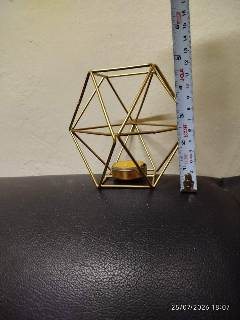 Geometric Gold Metal Candle Holder Set (Category: Other Home Decor) located in Quezon City. Submitted by chadrison (Listing ID 1451823044, Image 3). Description: - Set of 2 connected geometric gold metal candle holders - Unique hexagonal prism shape - Perfect for tea lights or small pillar candles - Adds a modern touch to any space - Great for home decor or events.