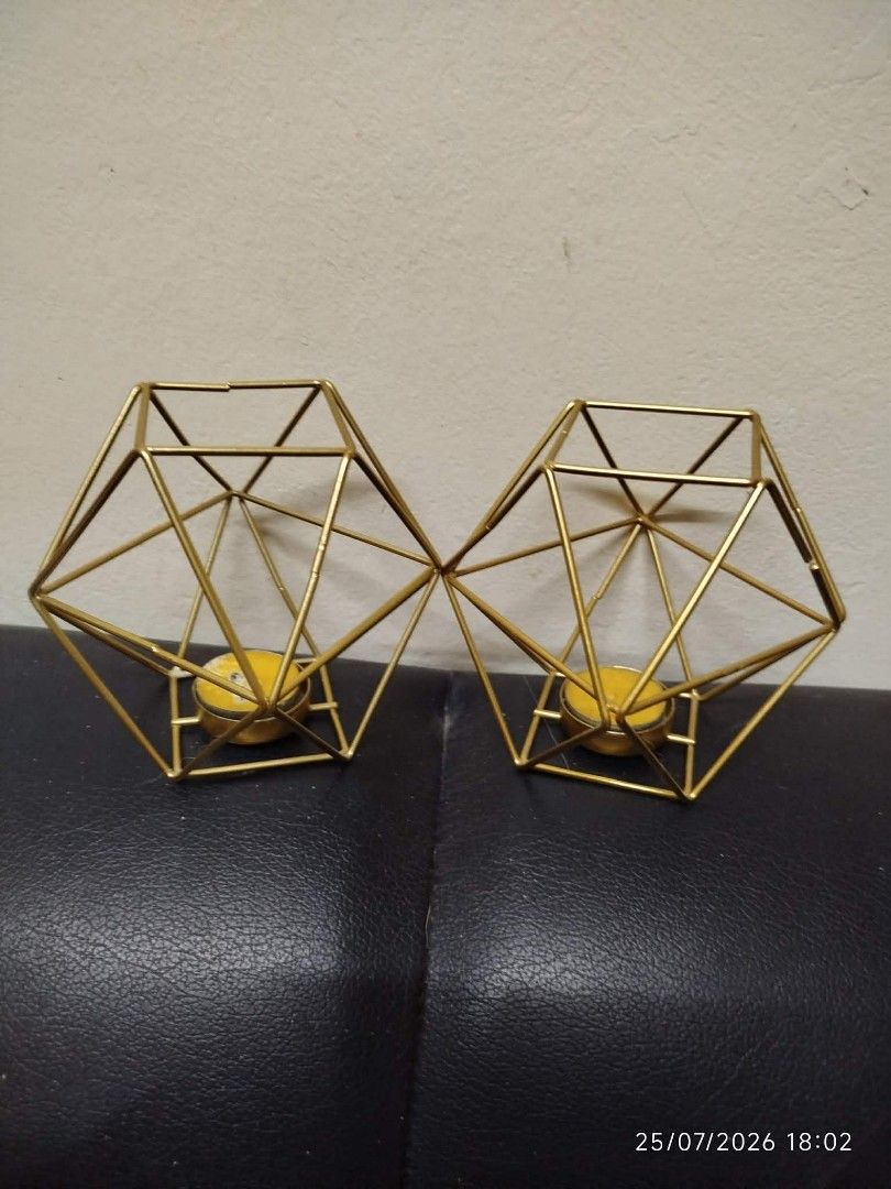 Geometric Gold Metal Candle Holder Set (Category: Other Home Decor) located in Quezon City. Submitted by chadrison (Listing ID 1451823044, Image 2). Description: - Set of 2 connected geometric gold metal candle holders - Unique hexagonal prism shape - Perfect for tea lights or small pillar candles - Adds a modern touch to any space - Great for home decor or events.