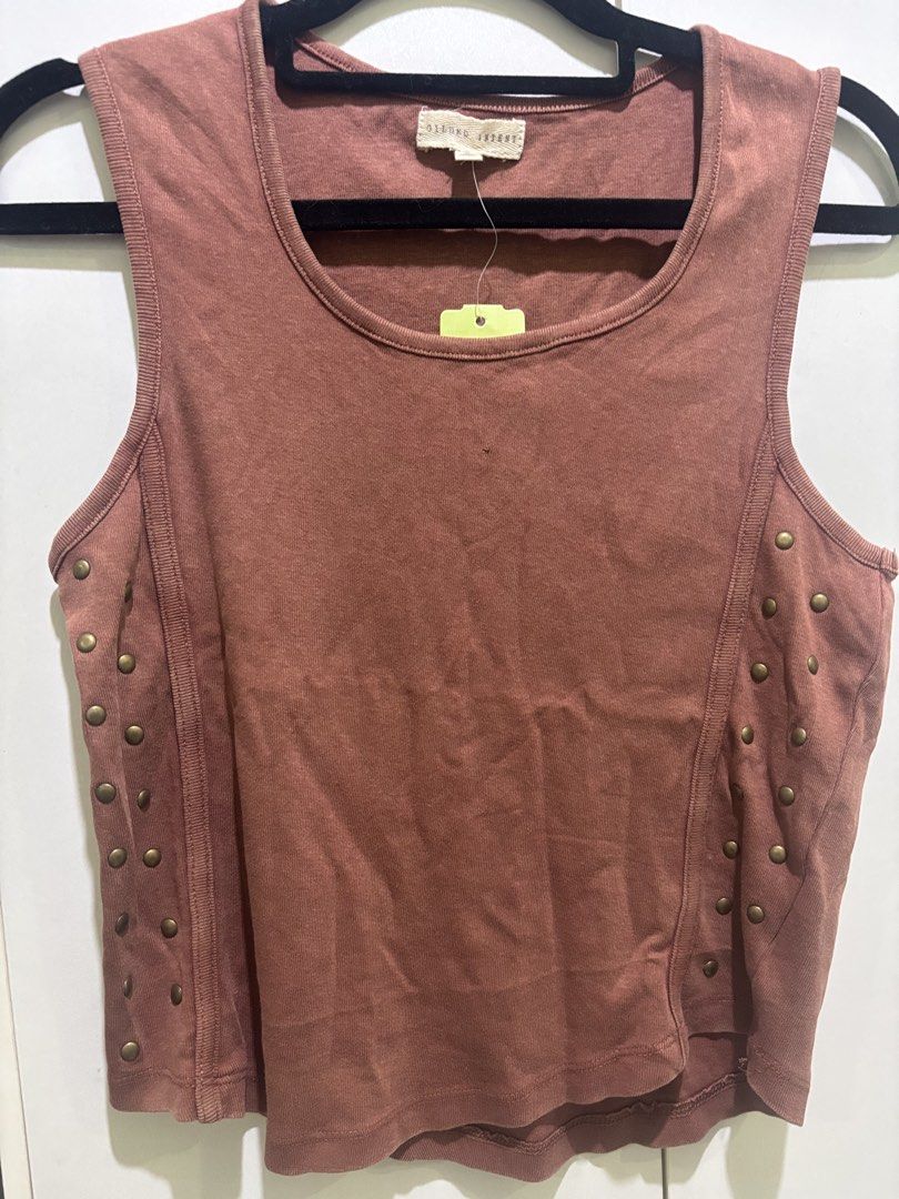 Gilded Intent Brown Studded Tank Top Size S (Category: Sleeveless) located in Las Pinas. Submitted by katb86 (Listing ID 1451780802, Image 2). Description: - Brand: Gilded Intent - Color: Brown - Style: Tank top, sleeveless - Features: Unique stud details on the sides - Occasion: Casual wear, layering -model is wearing a different top but similar style .