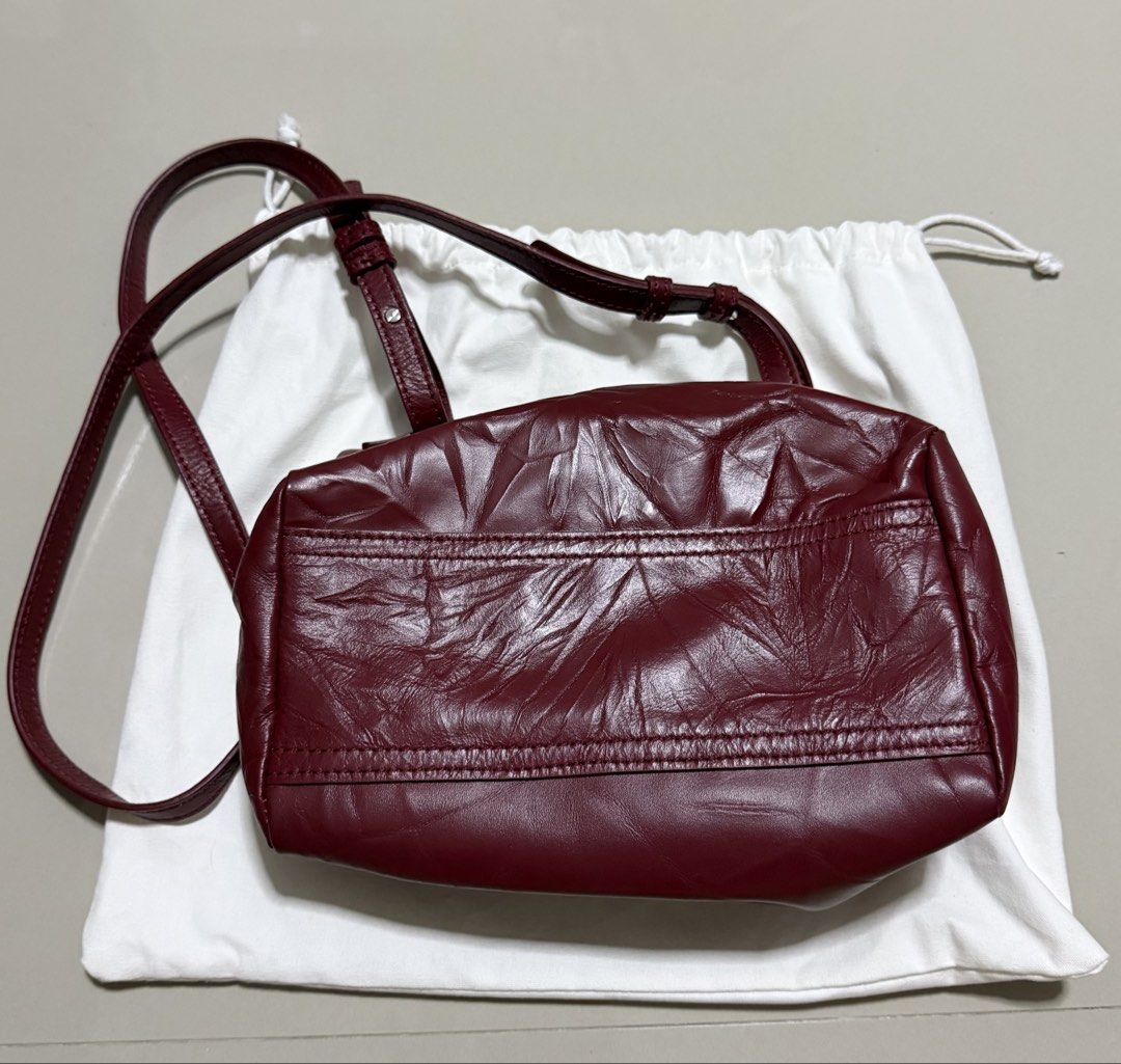 Givenchy Burgundy Mini Pandora (Category: Luxury Bags & Wallets) located in Pasig City. Submitted by dancieaa03 (Listing ID 1451872352, Image 3). Description: - Givenchy Mini Pandora bag in rich burgundy sugar leather. - Signature slouchy silhouette for effortless style. - Multiple zippered compartments for organized storage. - Elegant silver-tone hardware. - Comes with dust bag. This bag is NGA.