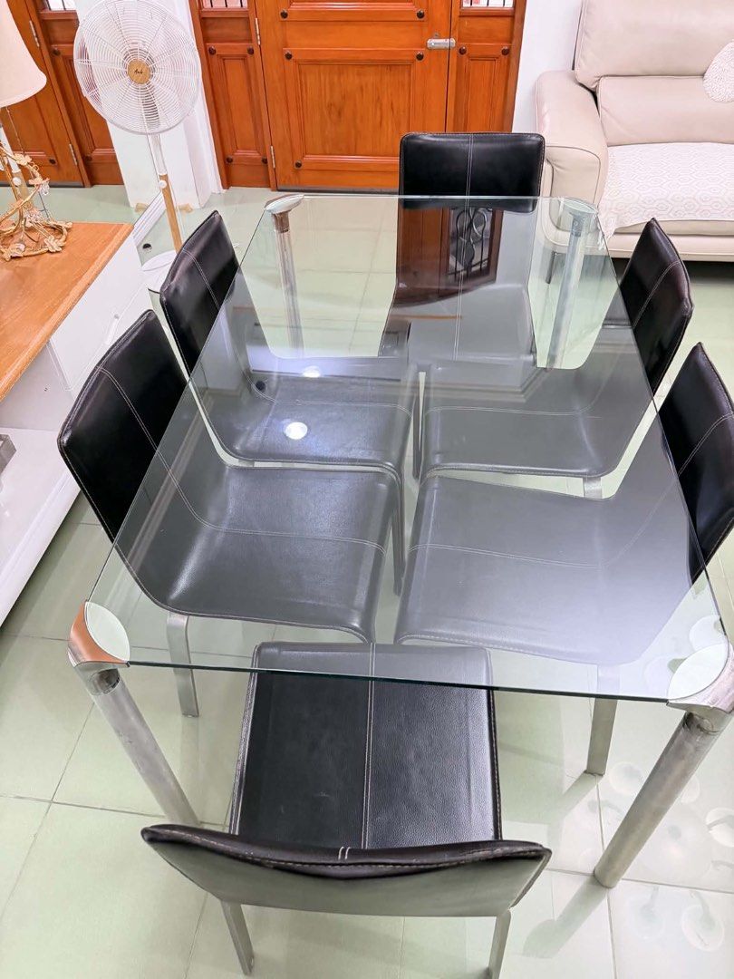 Glass Top Dining Table with 6 Black Chairs (Category: Tables & Sets) located in Binangonan. Submitted by blairmayie (Listing ID 1451761364, Image 2). Description: - Sleek glass top dining table with a sturdy metal frame. - Includes 6 comfortable black faux leather upholstered chairs. - Chairs feature durable metal legs. - Comfortably seats up to 6 people. - Ideal for family dinners and hosting guests. - Ready to upgrade your dining space!.