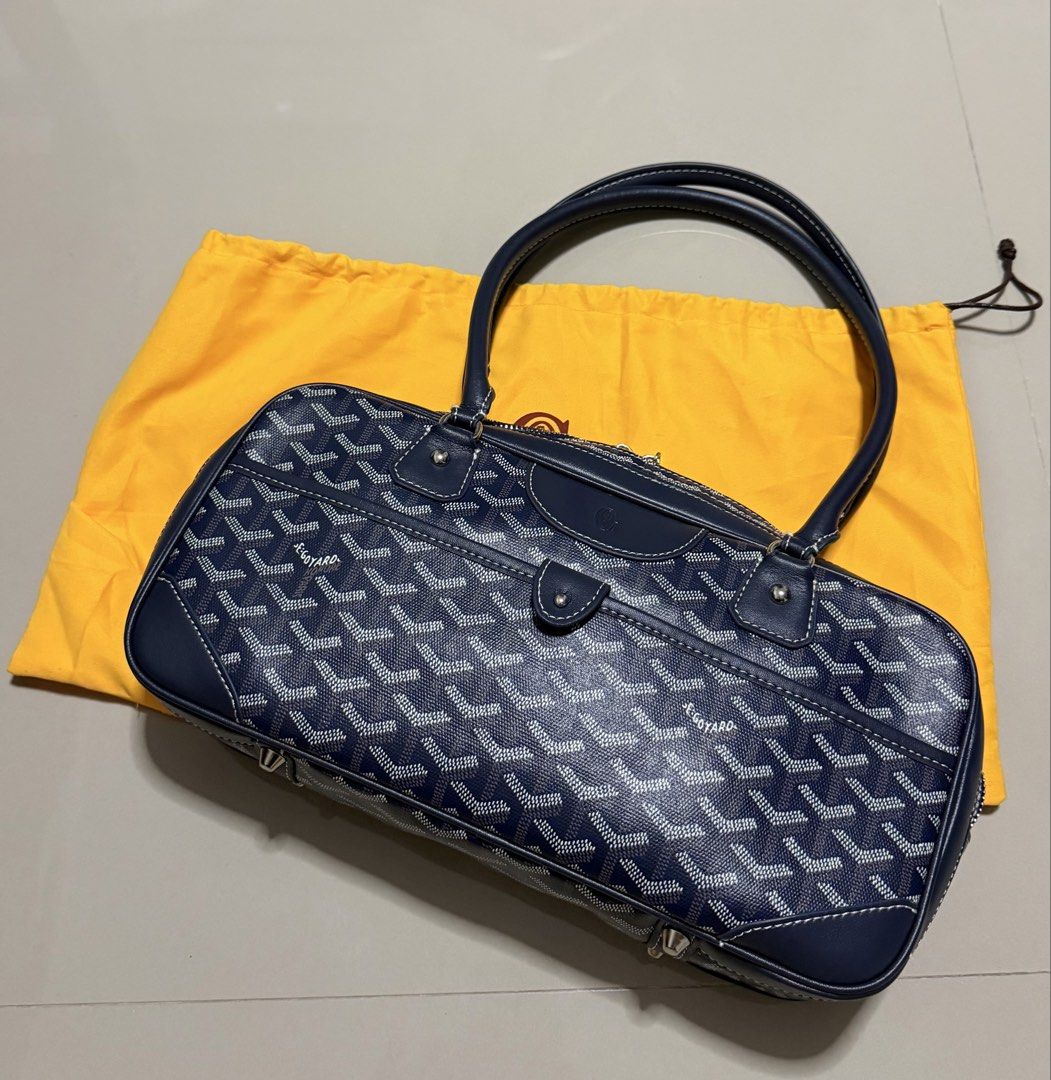 Goyard Navy St. Martin Bag (Category: Luxury Bags & Wallets) located in Pasig City. Submitted by dancieaa03 (Listing ID 1451876447, Image 1). Description: - Classic Goyard Boston bag in navy blue - Features the iconic Goyard monogram pattern - Genuine leather handles and trim - Secure zipper closure - Comes with Goyard dust bag - Stylish and practical for everyday use - Ample interior space This bag is NGA.